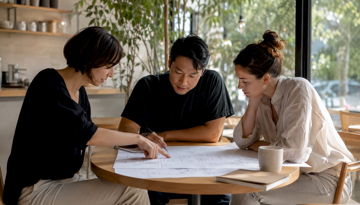 Team collaborating on business system flowcharts