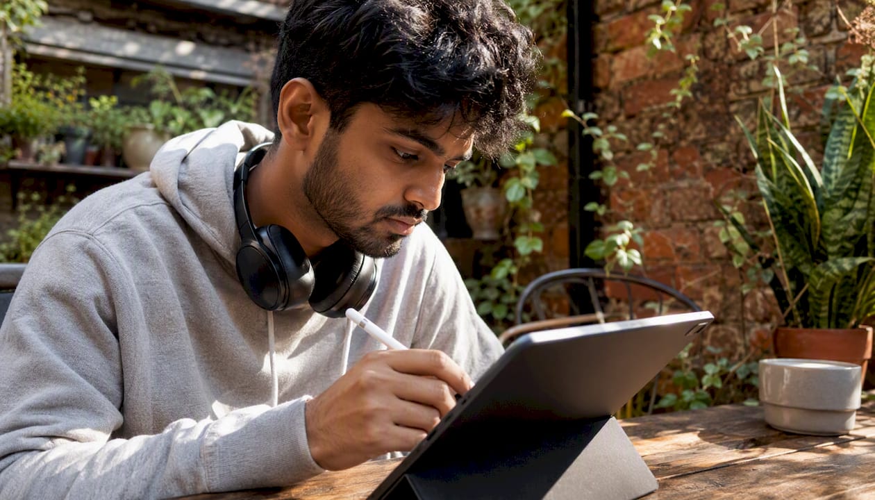 Man using tablet to explore website building tools