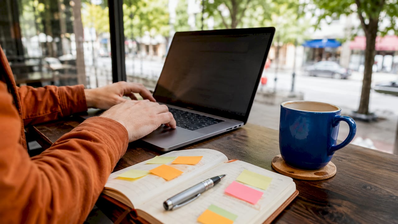 Hands typing code review notes on laptop keyboard
