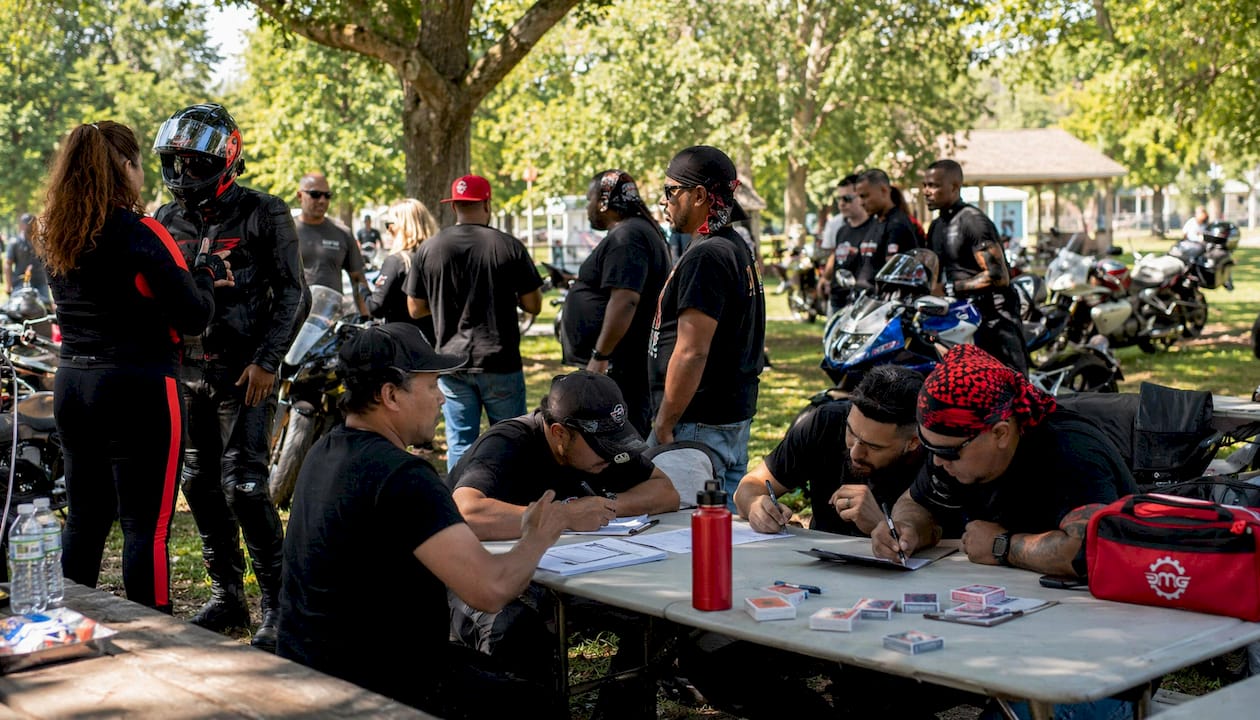 Motorcycle riders gathering for poker run registration