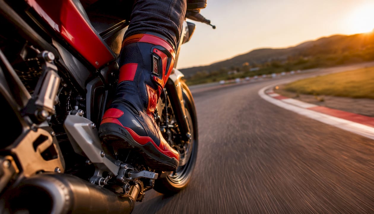 Rider’s foot using quickshifter on racetrack