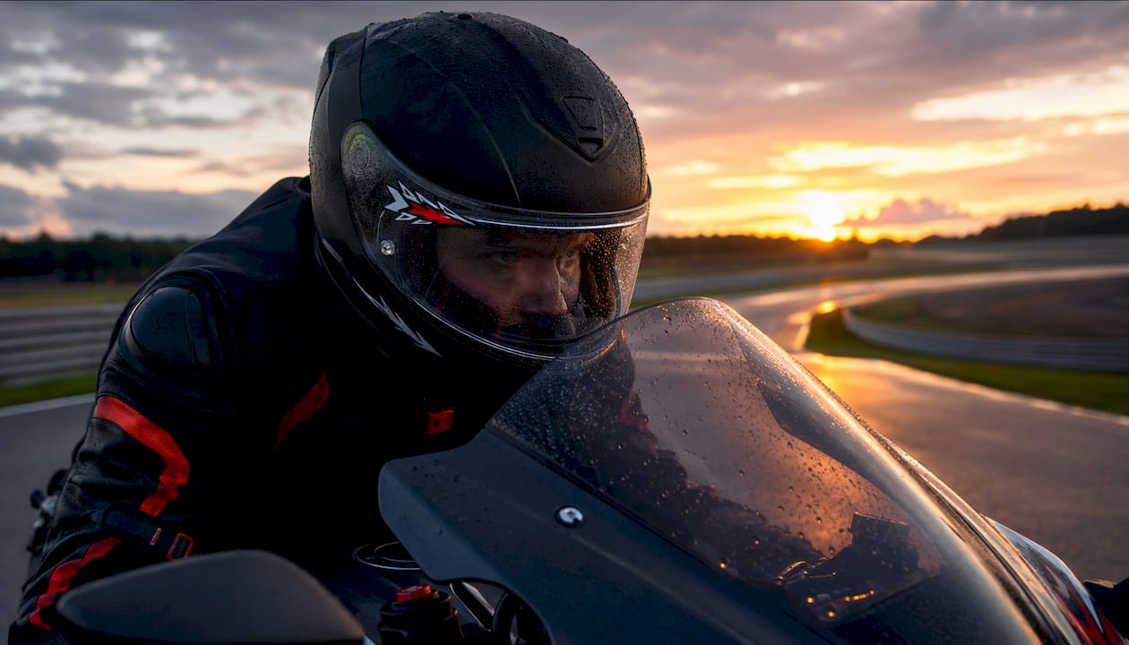 Close-up of rider behind windshield with airflow visuals