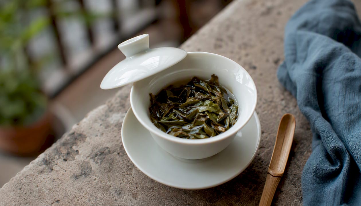 Porcelain gaiwan with tea leaves inside