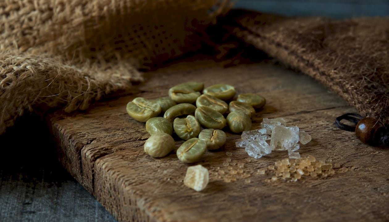 Close-up of green coffee beans with chemical compound hints