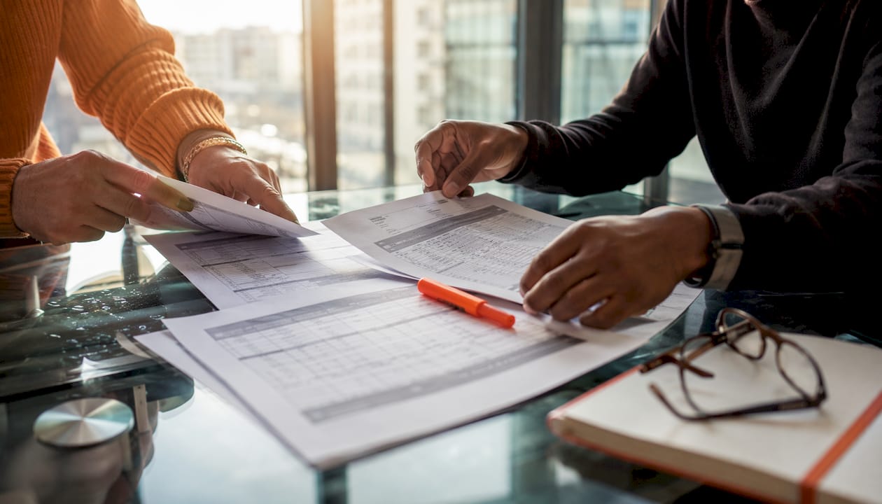 Hands sorting van rental fee papers on desk