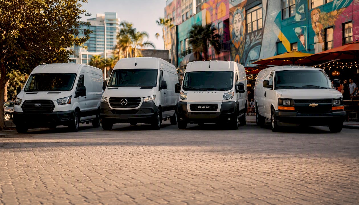 Four major big white van models aligned outside