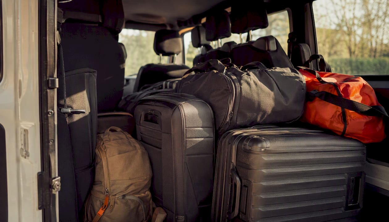 Packed luggage inside passenger van cargo area