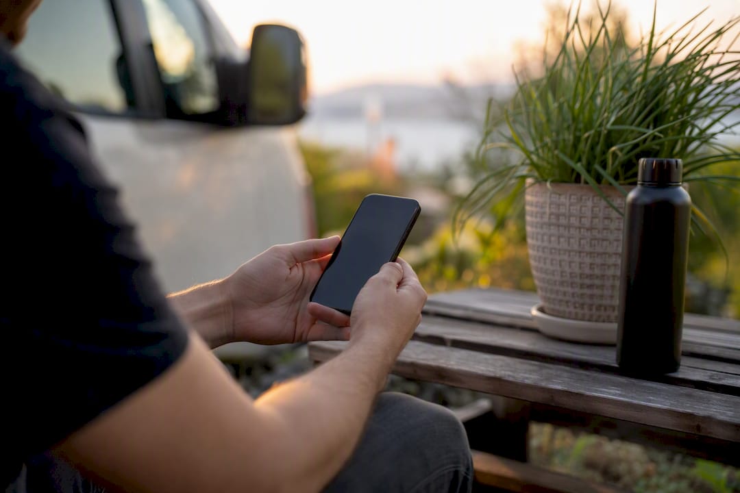 Hands reviewing rental details on phone