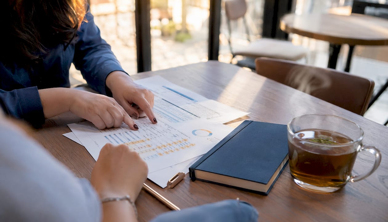 Hands pointing at construction financial reports