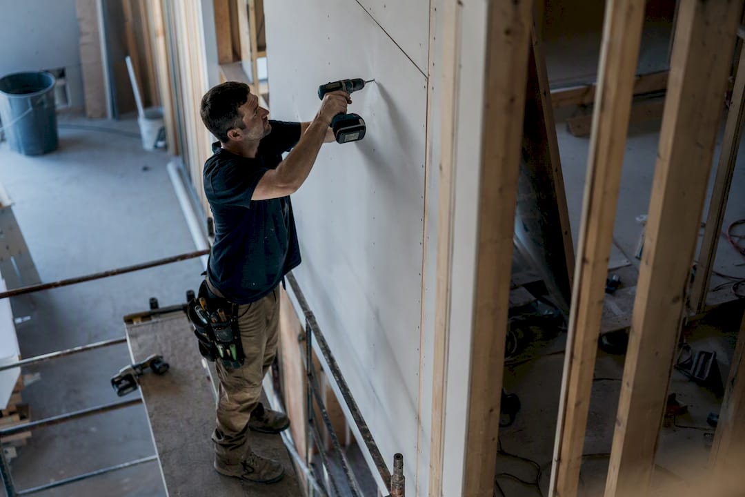 Drywall installer at work framing close-up