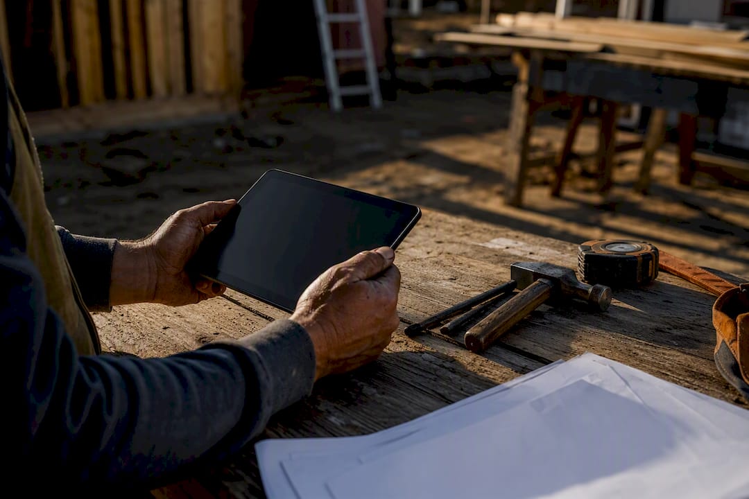 Hands placing tablet on workbench at site