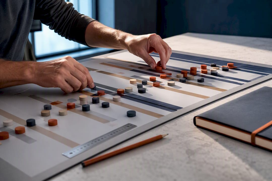 Hands arranging a cost-loaded construction schedule