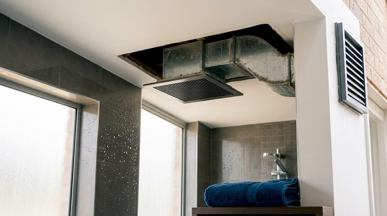 Bathroom fan grille and duct ventilation close-up