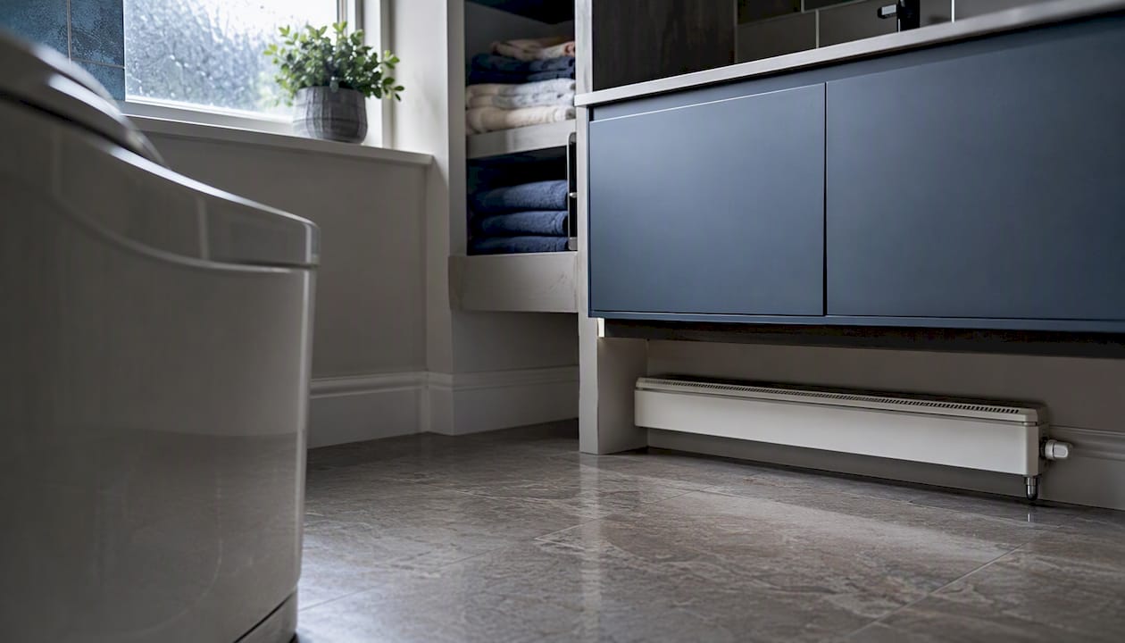 Compact bathroom with low profile radiator