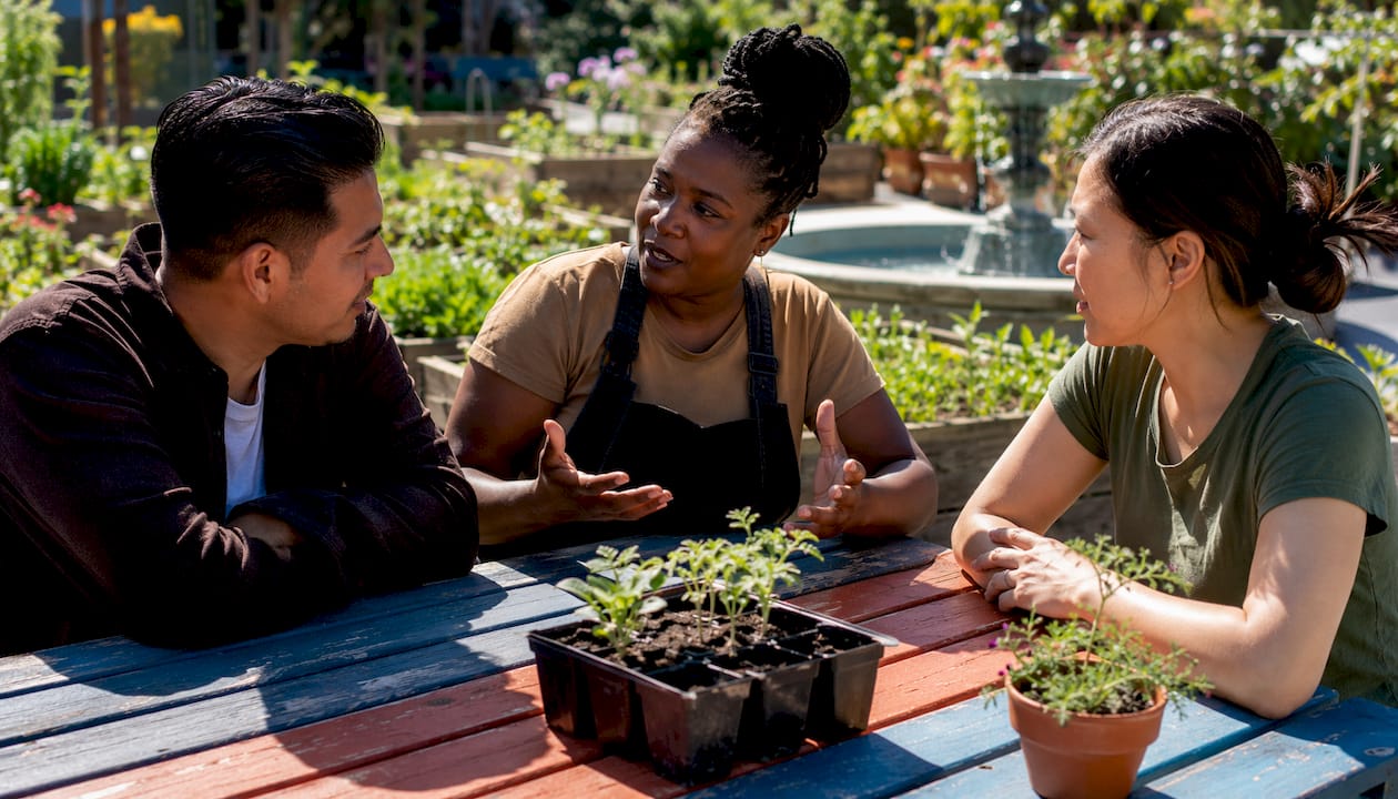 Diverse immigrants chatting together on park bench