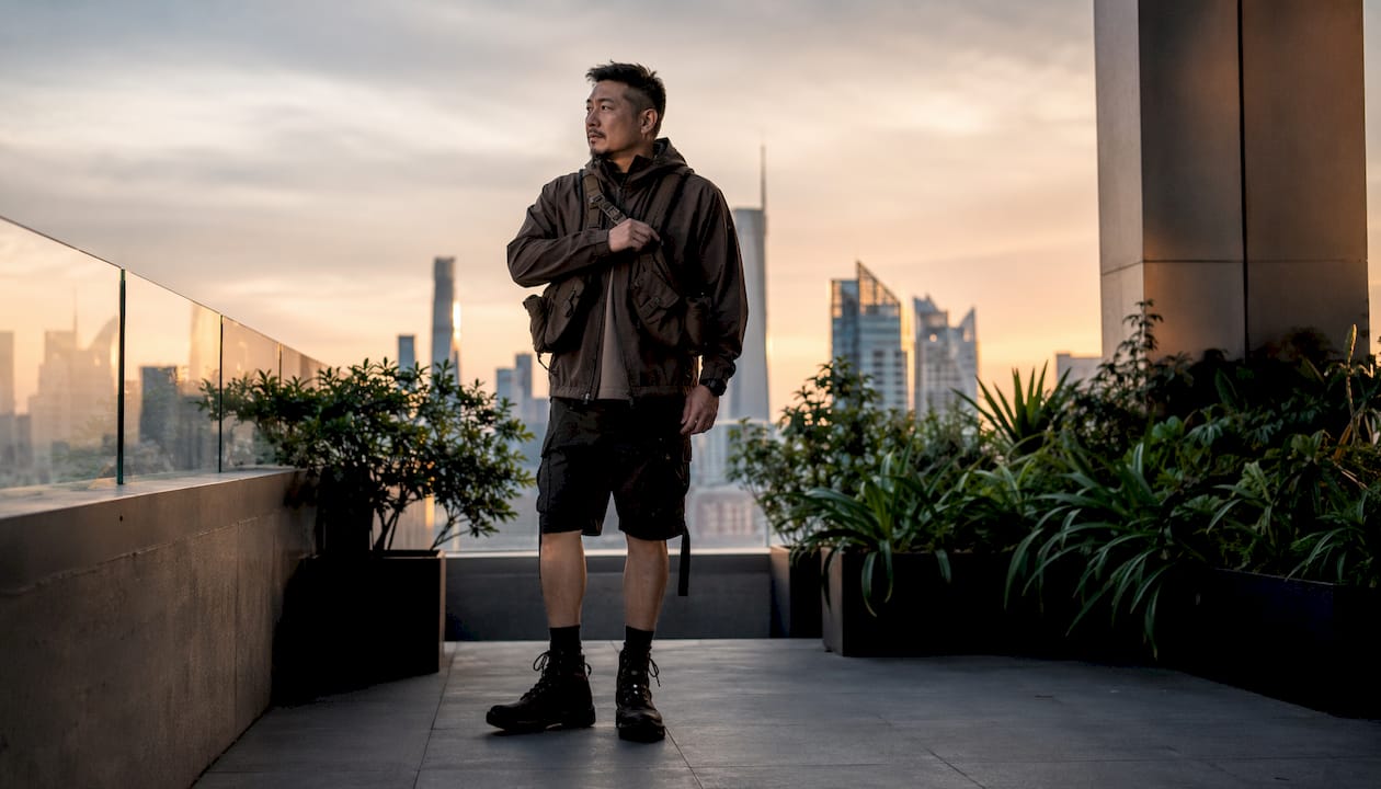Man wearing techwear on city rooftop