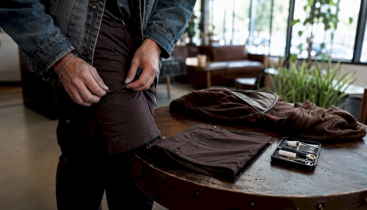 Hands showing modular zip-off pants feature