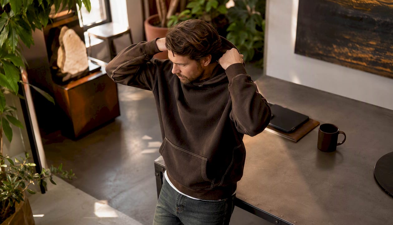Man walking outdoors wearing durable hoodie