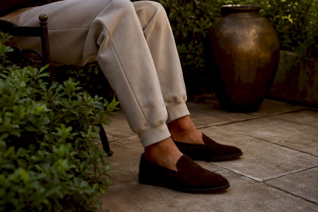 Close-up tapered joggers with loafers indoors