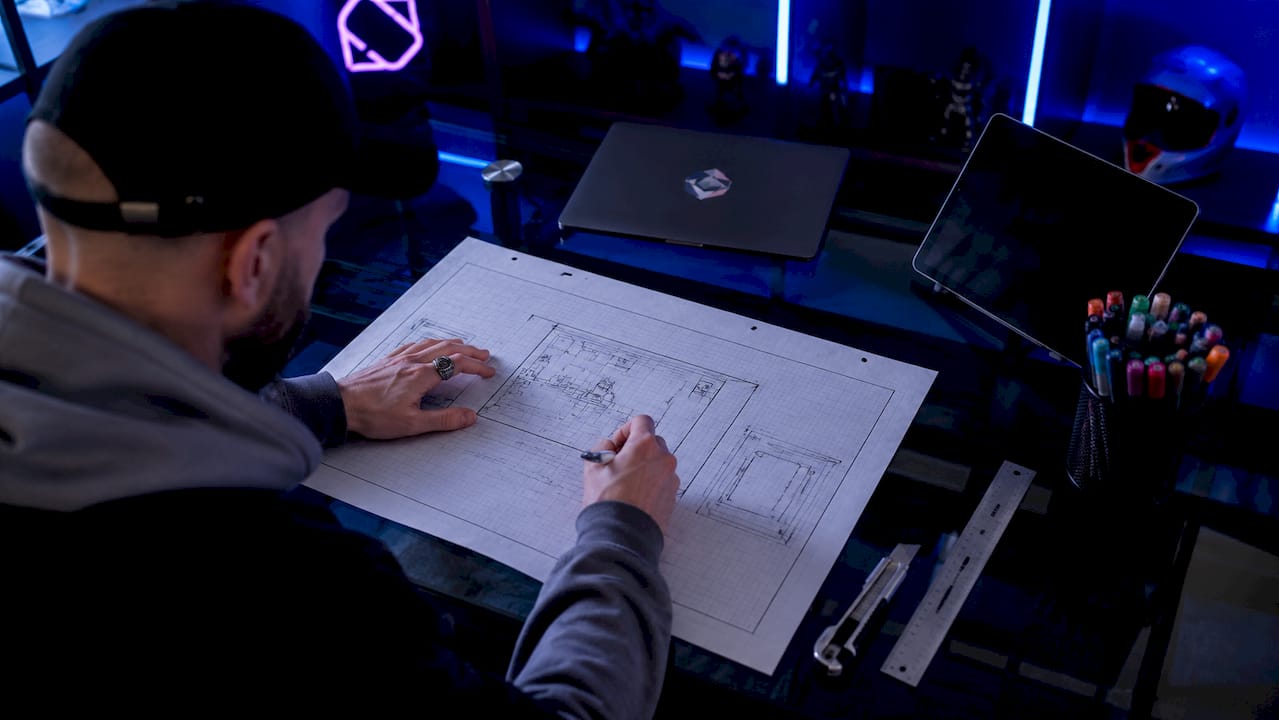 Hands sketching stream overlay layout in OBS