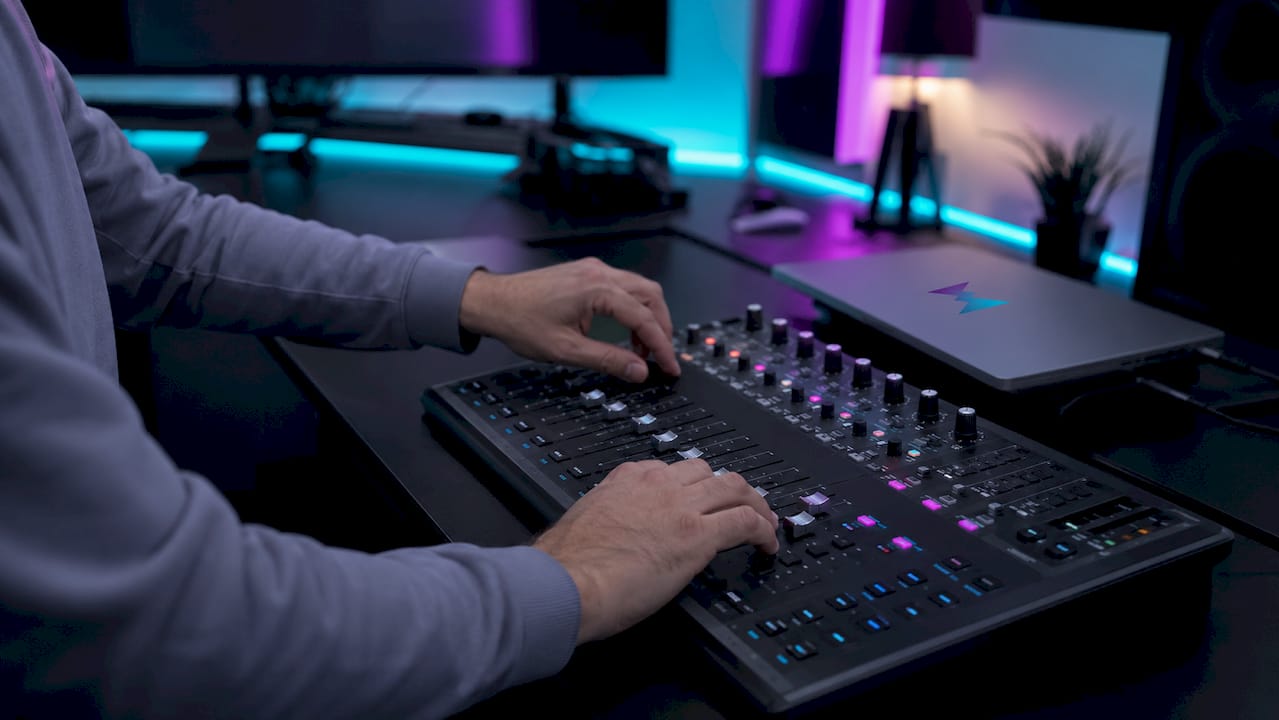 Hands adjusting stream alert sound mixer controls