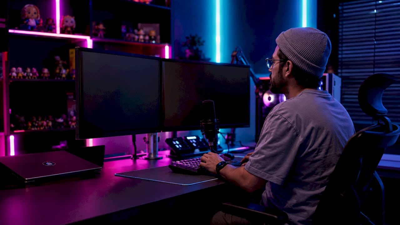 Hands controlling OBS overlay setup on desktop PC
