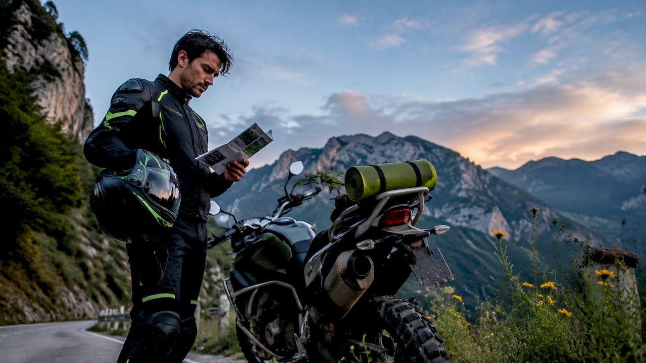 Rider studying adventure bike cc licensing guide outdoors