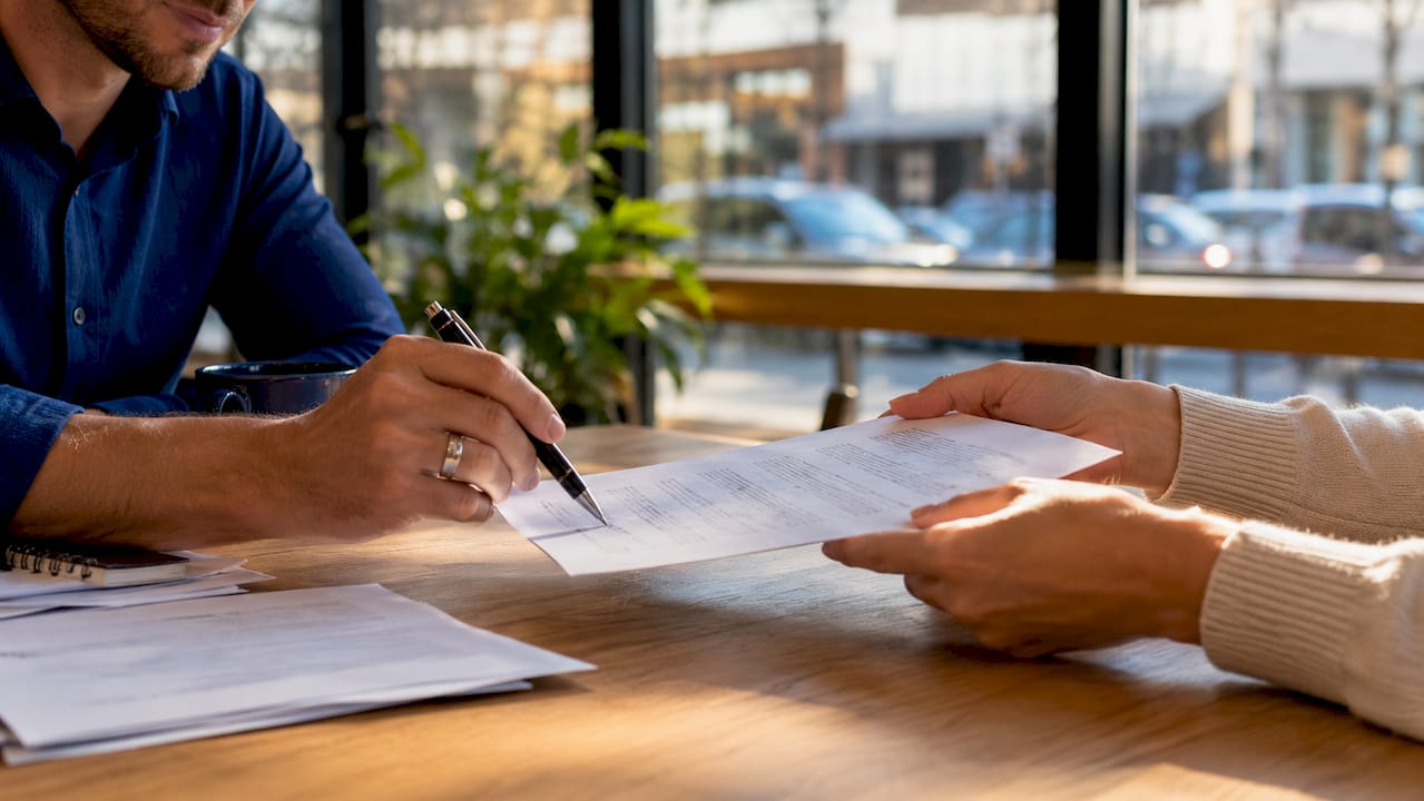 Close-up hands signing lease agreement