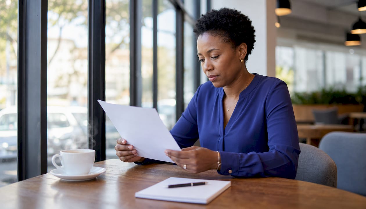 Woman reading bond agreement in home office