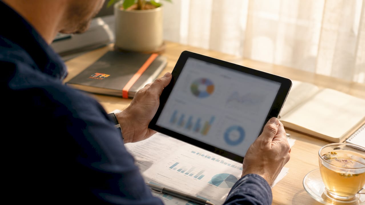Hands holding tablet showing insurance data