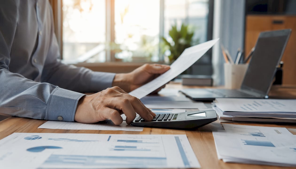 Hands calculating corporate hospitality budget