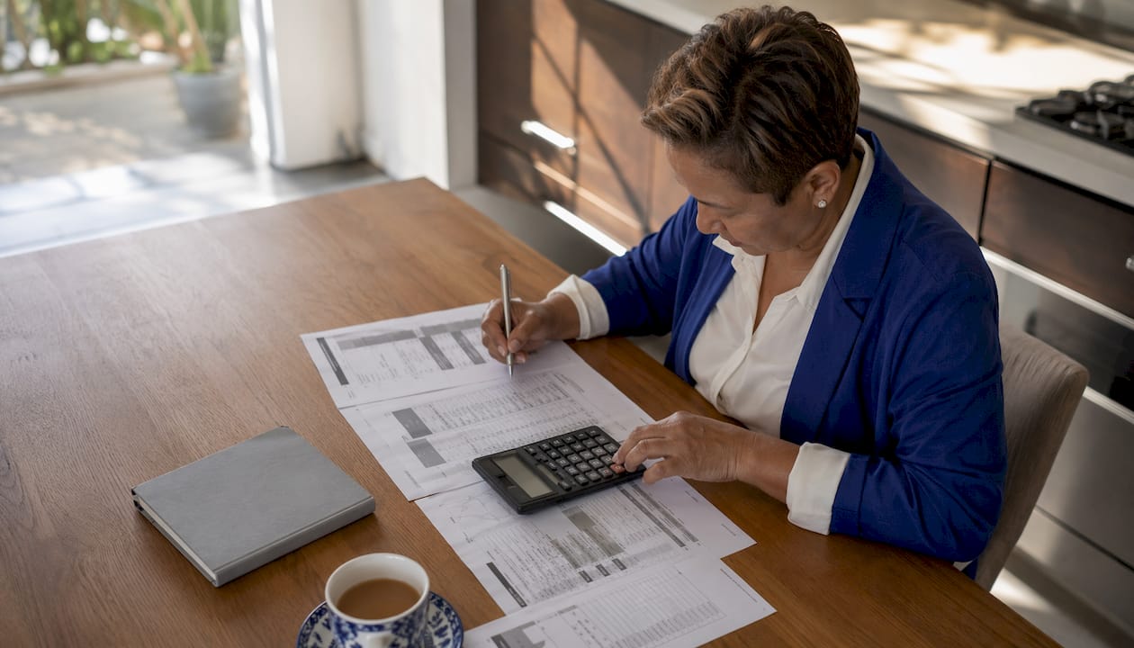 Estate agent calculating property pricing