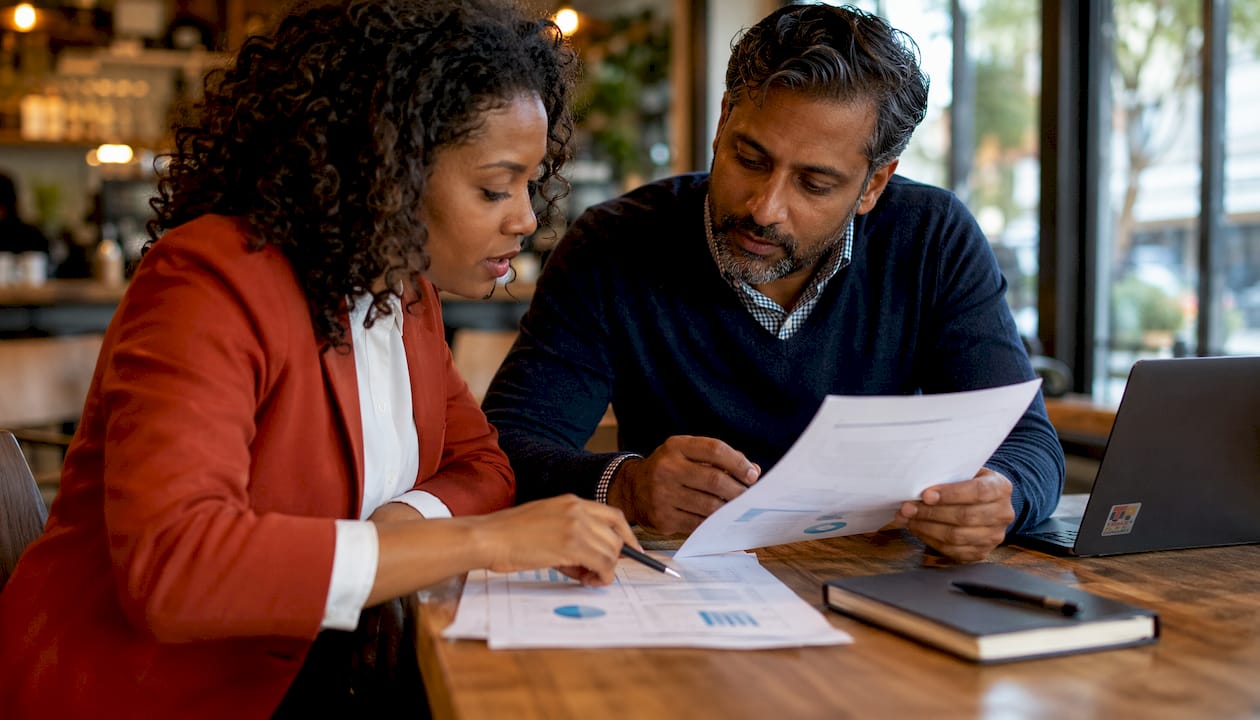 Two professionals reviewing fleet insurance claim documents