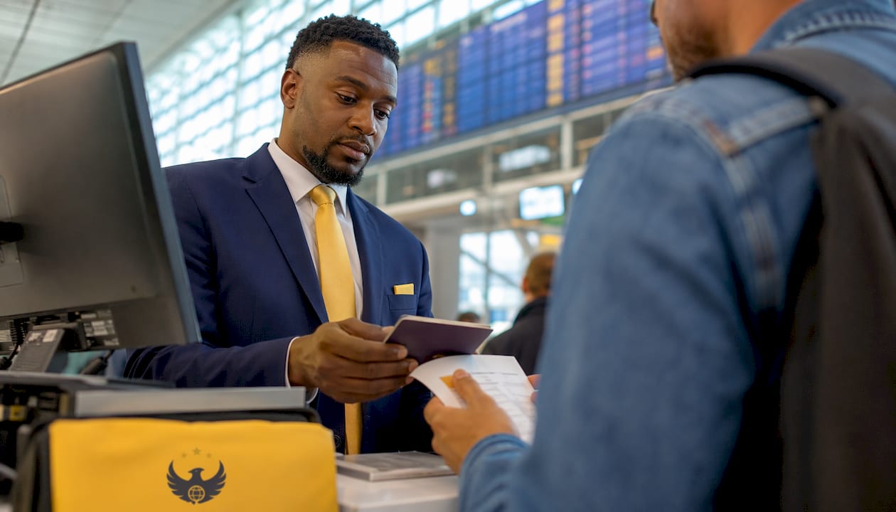 Airline agent verifying passport at check-in
