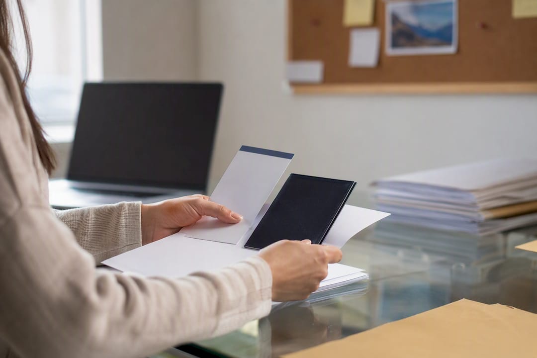 Hands arranging travel proof documents on table