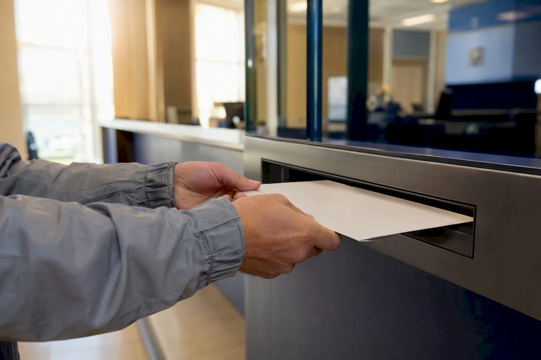 Courier delivering passport envelope at agency
