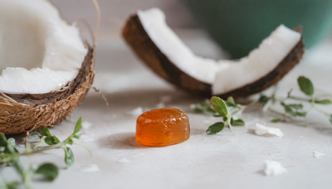 Close-up of turmeric gummy with root and leaves