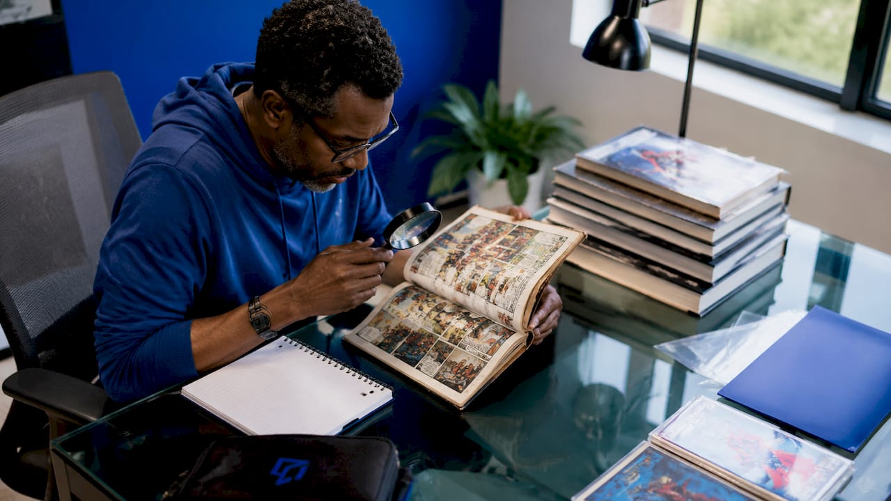 Collector inspecting comic book coupon cut detail