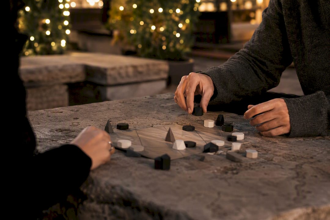 Hands coordinating pieces in cooperative game session