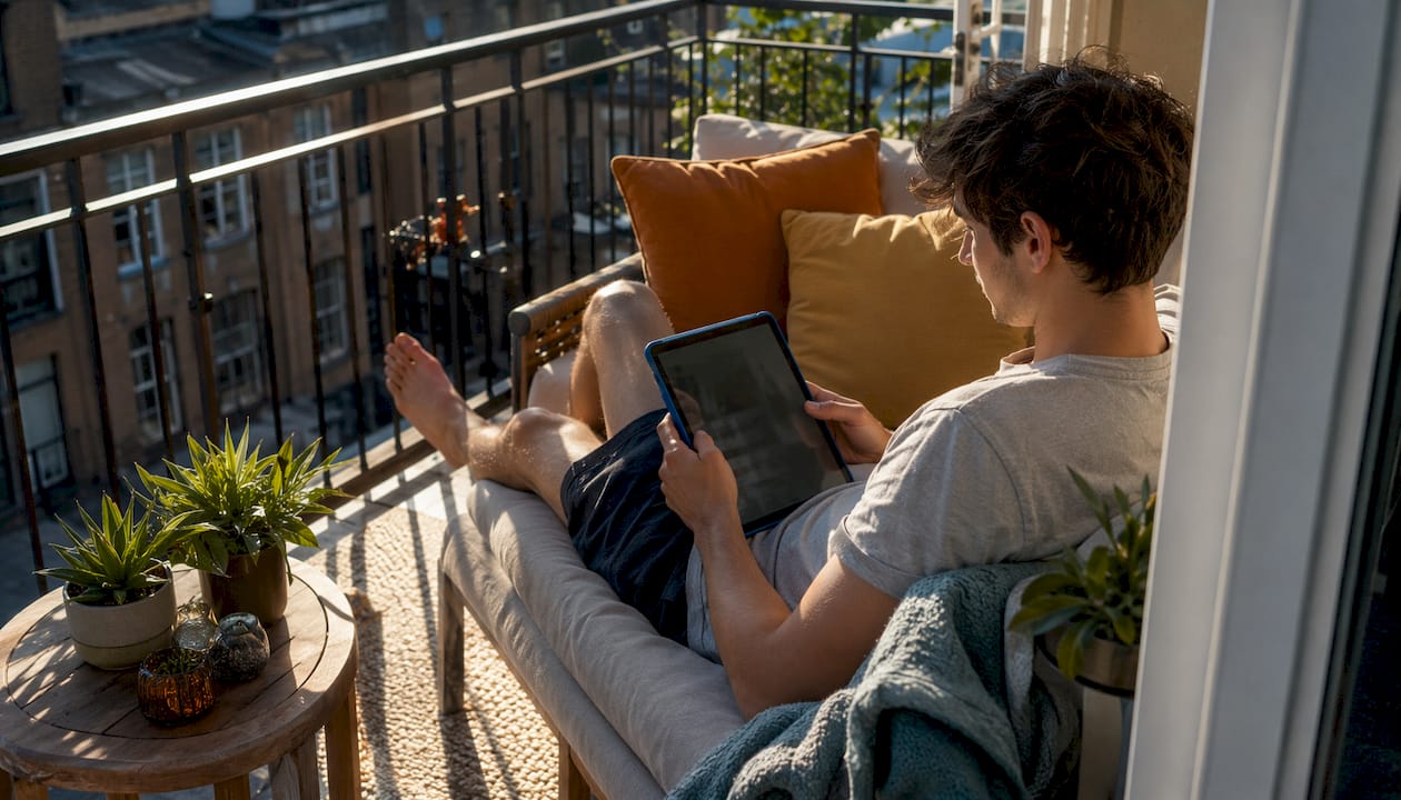 Young man browsing renter-friendly home decor sites