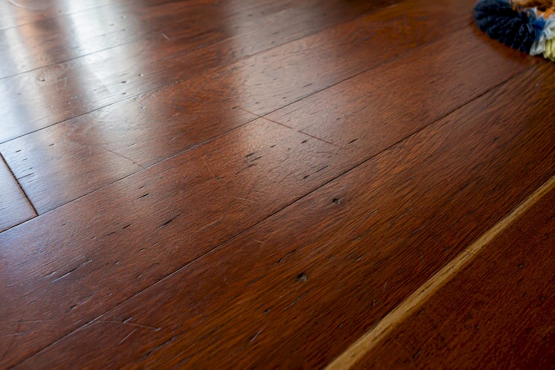 Close-up of dents and scratches on walnut floor