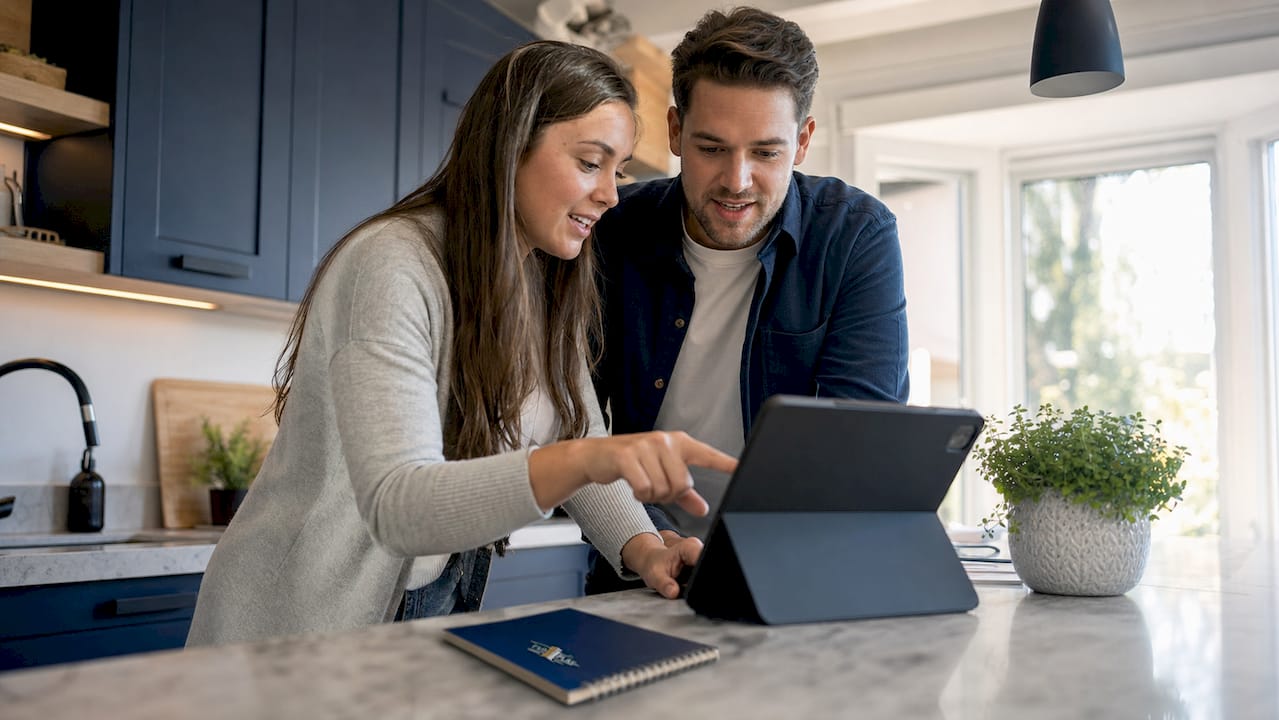 Couple discussing home loan options at laptop