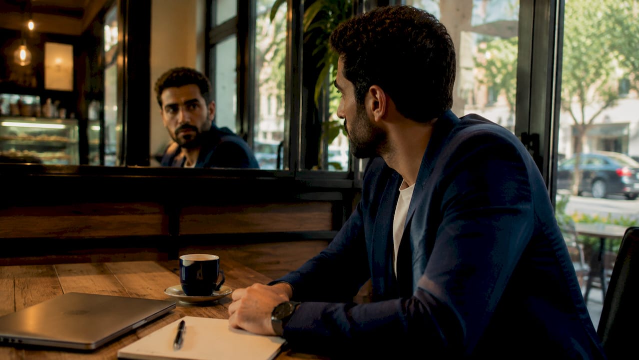 Man viewing reflection in coworking space window