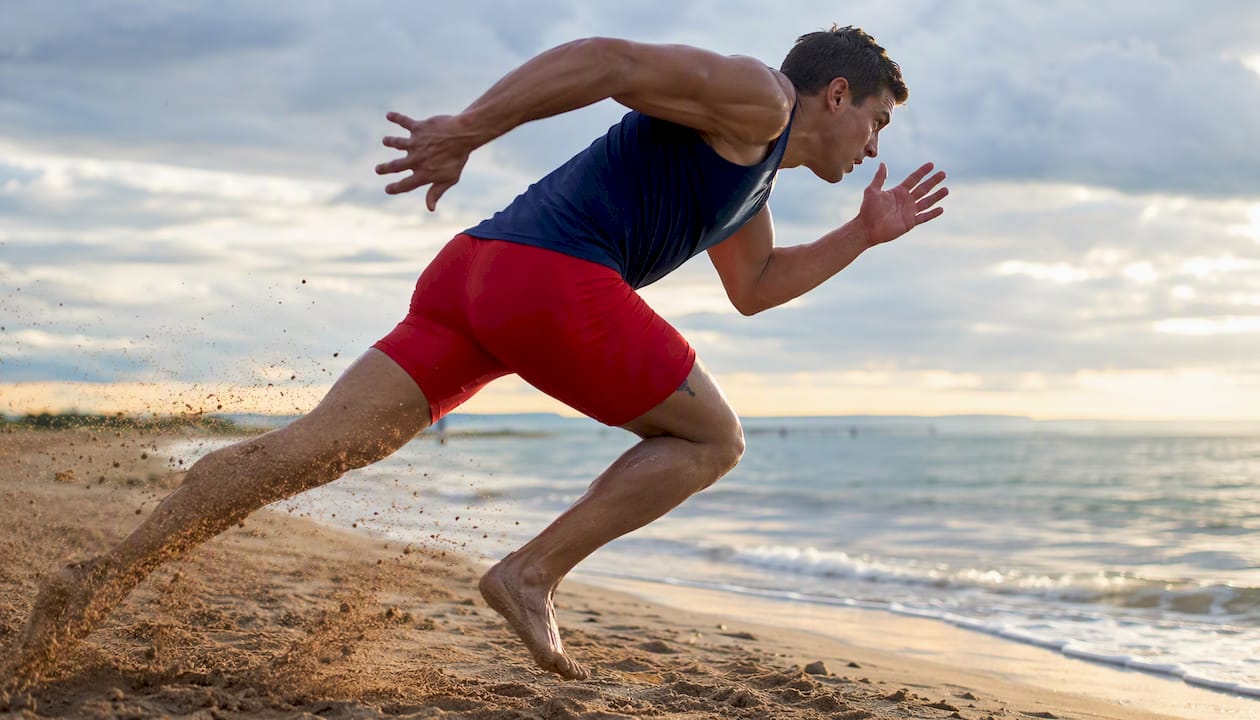 Athlete sprinting on track at full speed