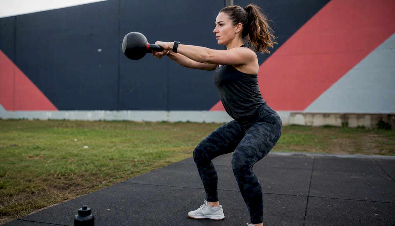 Athlete performing kettlebell swing showing kinetic chain