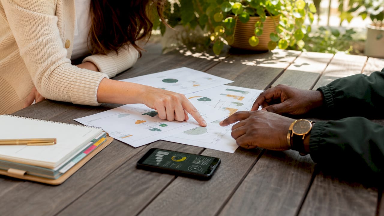 Two hands discussing virtual accounting workflow documents