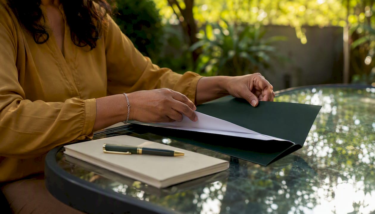Close-up of hands filing sales tax paperwork
