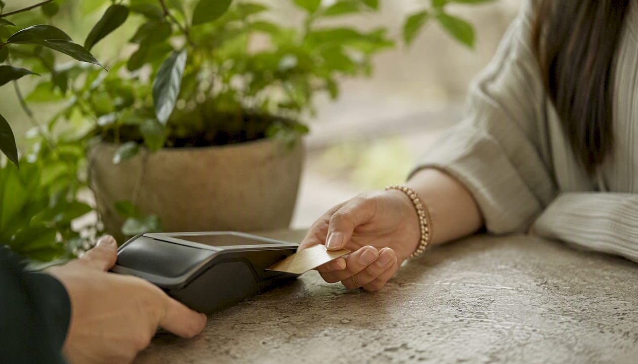 Hands inserting credit card for tax payment