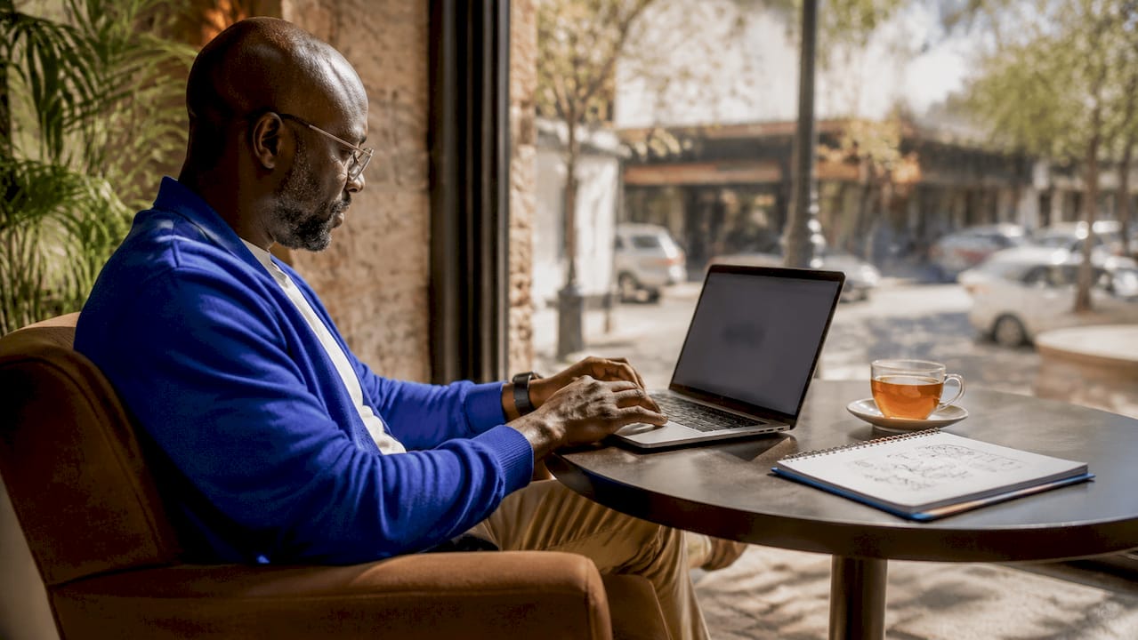 Man using client portal on laptop in home office
