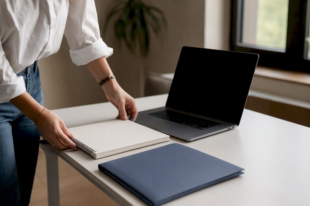 Coach’s hand placing mouse by laptop on desk